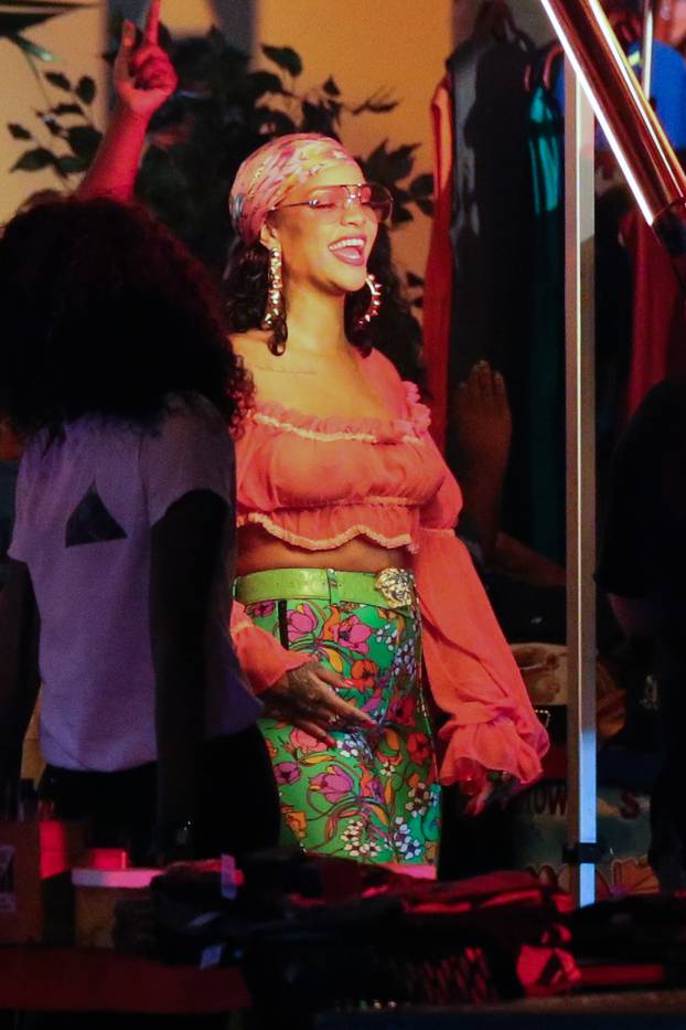 Rihanna rocks a pair of incredible skintight green print high-heeled pants as she films her new music video in the heart of Little Haiti in Miami, accompanied by DJ Khaled