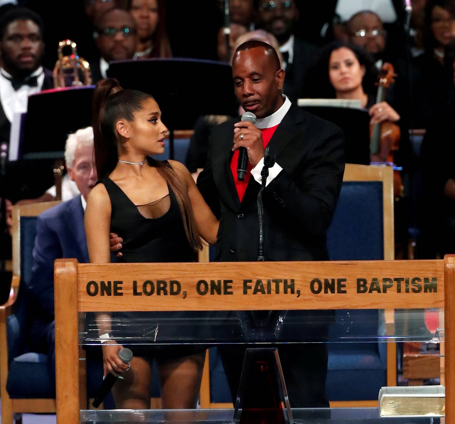 Pastor Charles speaks with singer Ariana Grande after she performed at the funeral service for Aretha Franklin at the Greater Grace Temple in Detroit