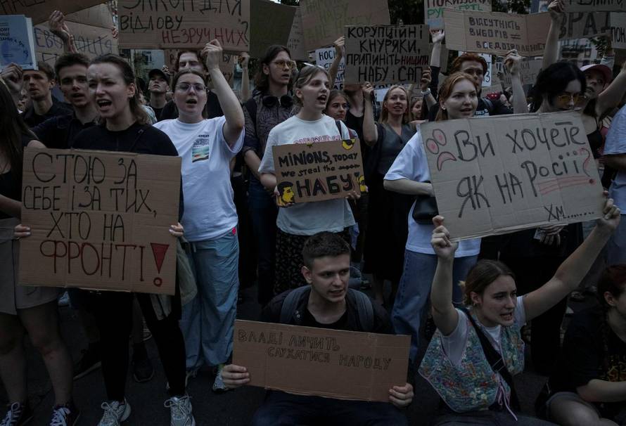 Ukrainians protest against a newly passed law, which curbs independence of anti-corruption institutions near the presidential office in Kyiv