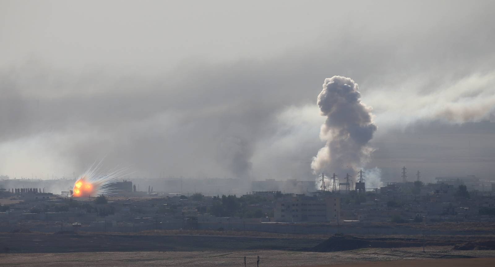 Explosion and smoke are seen over the Syrian town of Ras al-Ain as seen from the Turkish border town of Ceylanpinar