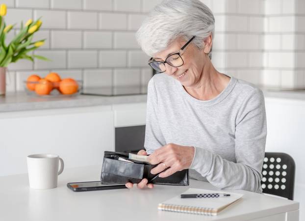 Smiling,Elderly,Woman,Counts,Euro,Money,In,Wallet