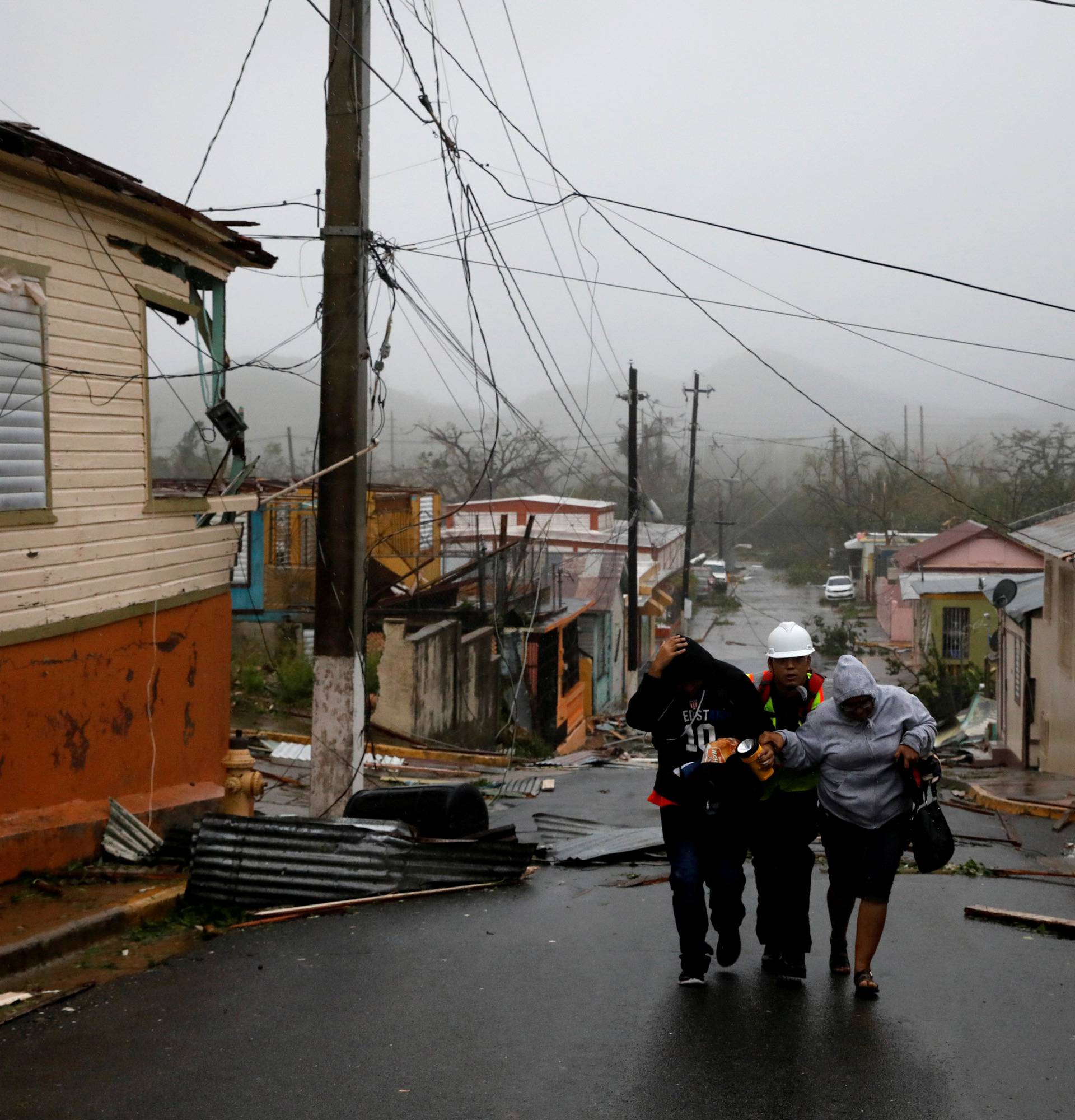 Rescue workers help people after the area was hit by Hurricane Maria in Guayama