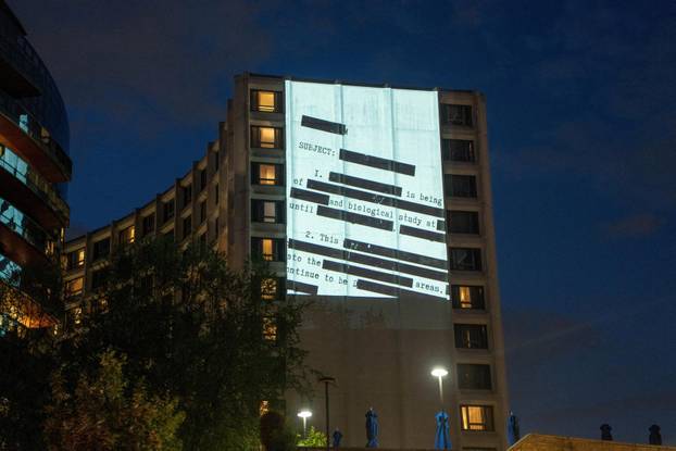 Documents and photos of Jeffrey Epstein and U.S. President Trump projected onto Hilton ahead of WHCA Gala, in Washington, D.C.