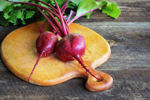Fresh beetroot on rustic wooden background. Harvest vegetable cooking conception . Diet or vegetarian food concept .