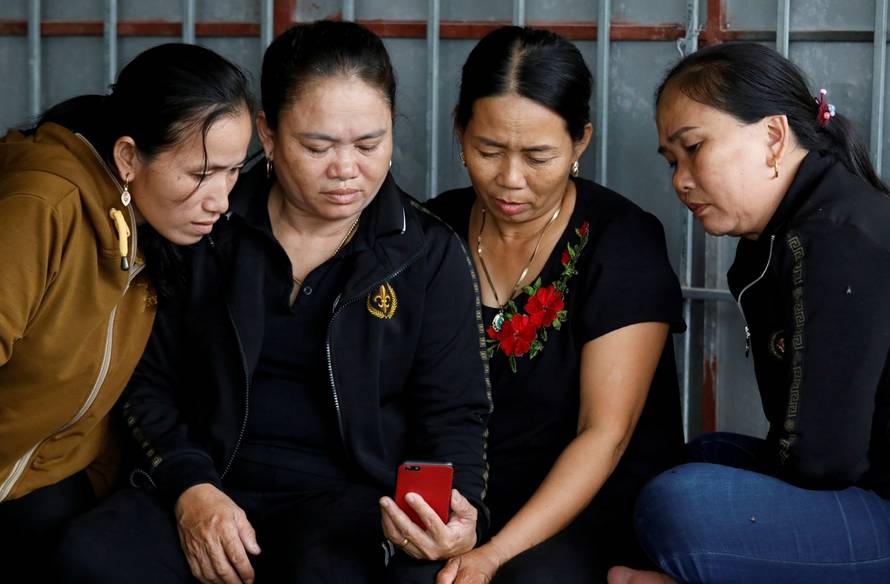 Relatives of Anna Bui Thi Nhung, a Vietnamese suspected to be among dead victims found in a lorry in Britain, read news about her at her home in Nghe An province