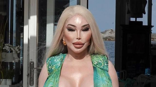 Former Human Ken doll Jessica Alves is pictured showing off her surgically enhanced cleavage while enjoying lunch in Ibiza.