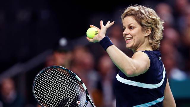 FILE PHOTO: Belgium's Clijsters waves to supporters during an exhibition tennis match to mark her retirement
