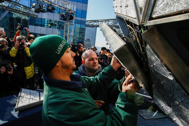 Workers install Waterford Crystal triangles on the Times Square New Year
