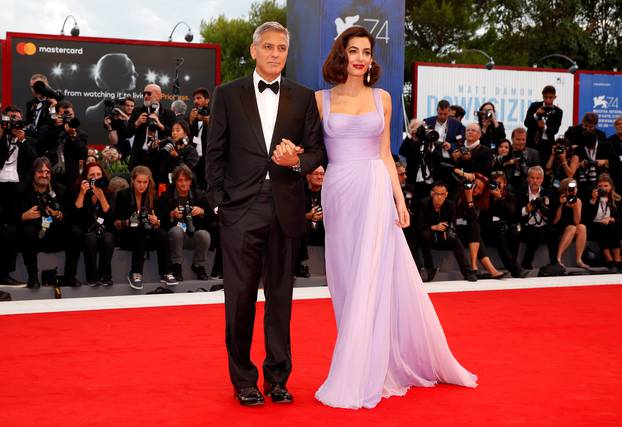 Actor and director George Clooney and his wife Amal pose during a red carpet event for the movie "Suburbicon" at the 74th Venice Film Festival in Venice, Italy