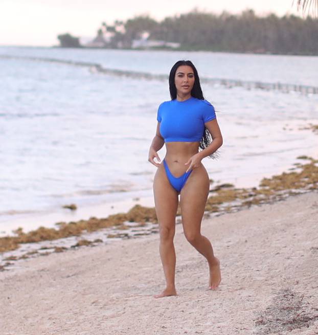 PREMIUM EXCLUSIVE: *NO WEB UNTIL 430PM EST 21ST JAN* Kim Kardashian shows off her sensational curves on a photo shoot for her SKIMS swimwear line on a tropical getaway