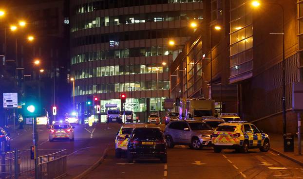 Vehicles are seen near a police cordon outside the Manchester Arena, where U.S. singer Ariana Grande had been performing, in Manchester, northern England, Britain