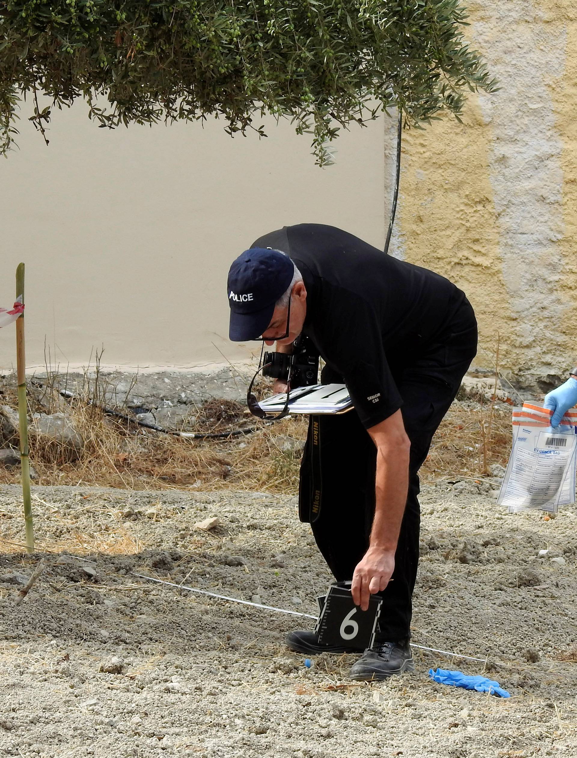 South Yorkshire police officers investigates the ground before commencing excavating a site for Ben Needham, a 21 month old British toddler who went missing in 1991, on the island of Kos