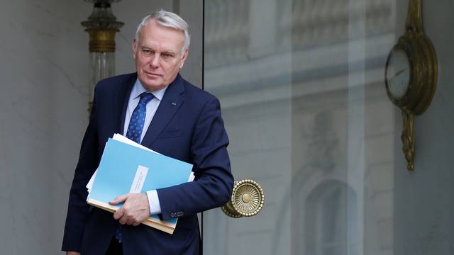 French Foreign Minister Jean-Marc Ayrault leaves the weekly cabinet meeting at the Elysee Palace in Paris
