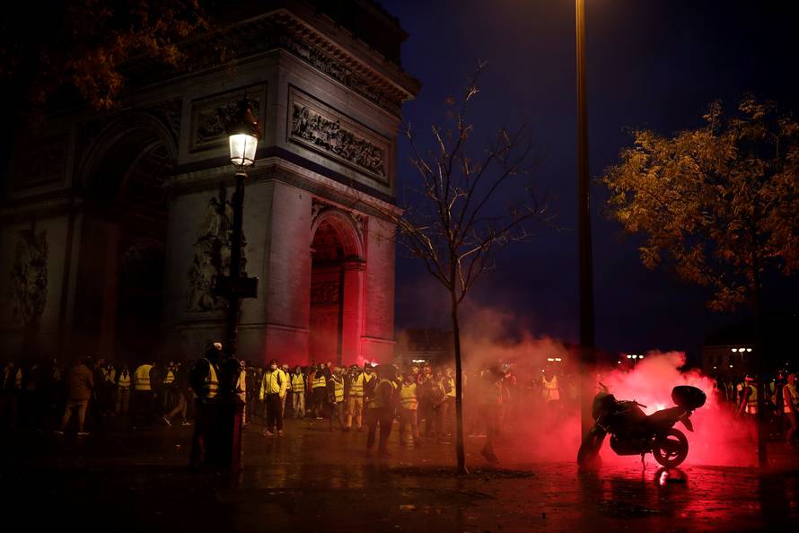 Protesters wearing yellow vests, a symbol of a French drivers' protest against higher diesel taxes, gather at the Place de l'Etoile near the Arc de Triomphe in Paris