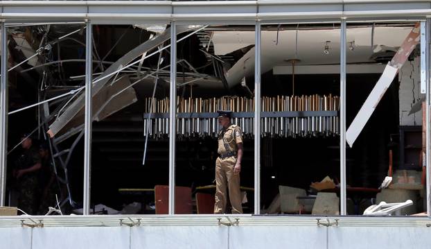 A police officer inspects the explosion area at Shangri-La hotel in Colombo