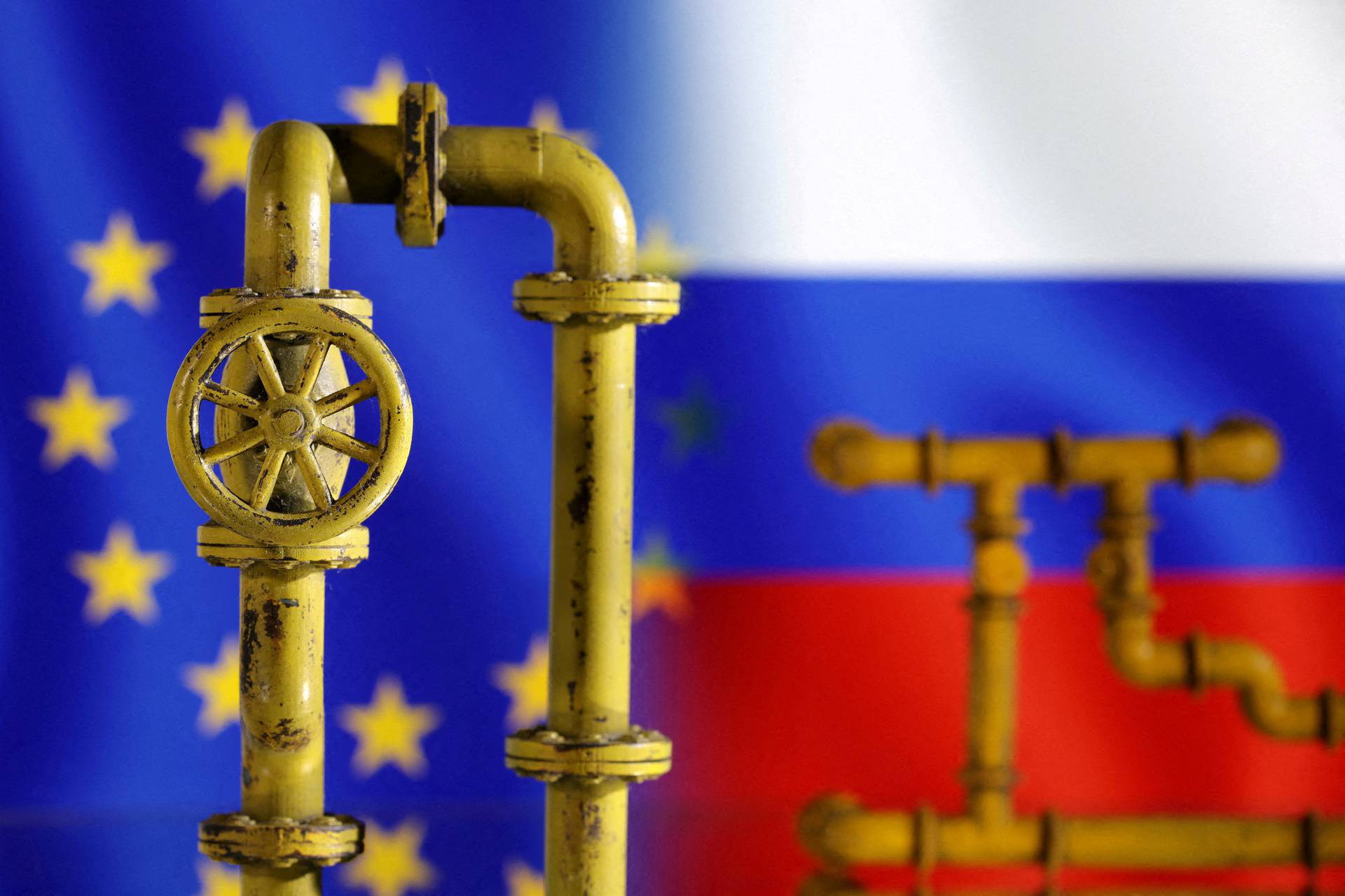 FILE PHOTO: Illustration shows natural gas pipeline, EU and Russia flags