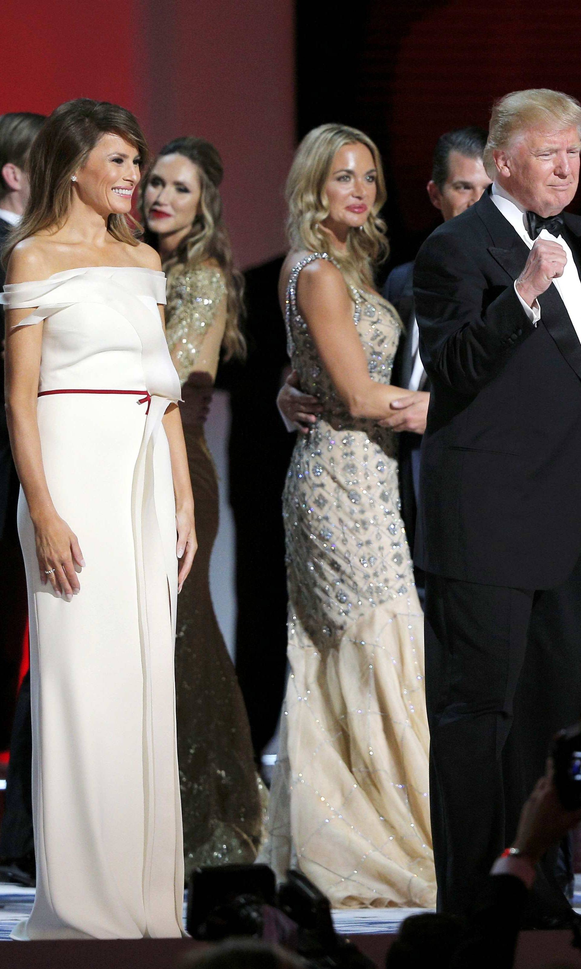 U.S. President Trump pumps his fists with wife Melania and members of their family after dancing their first dance to Frank Sinatra's song "My Way" at his "Liberty" Inaugural Ball in Washington