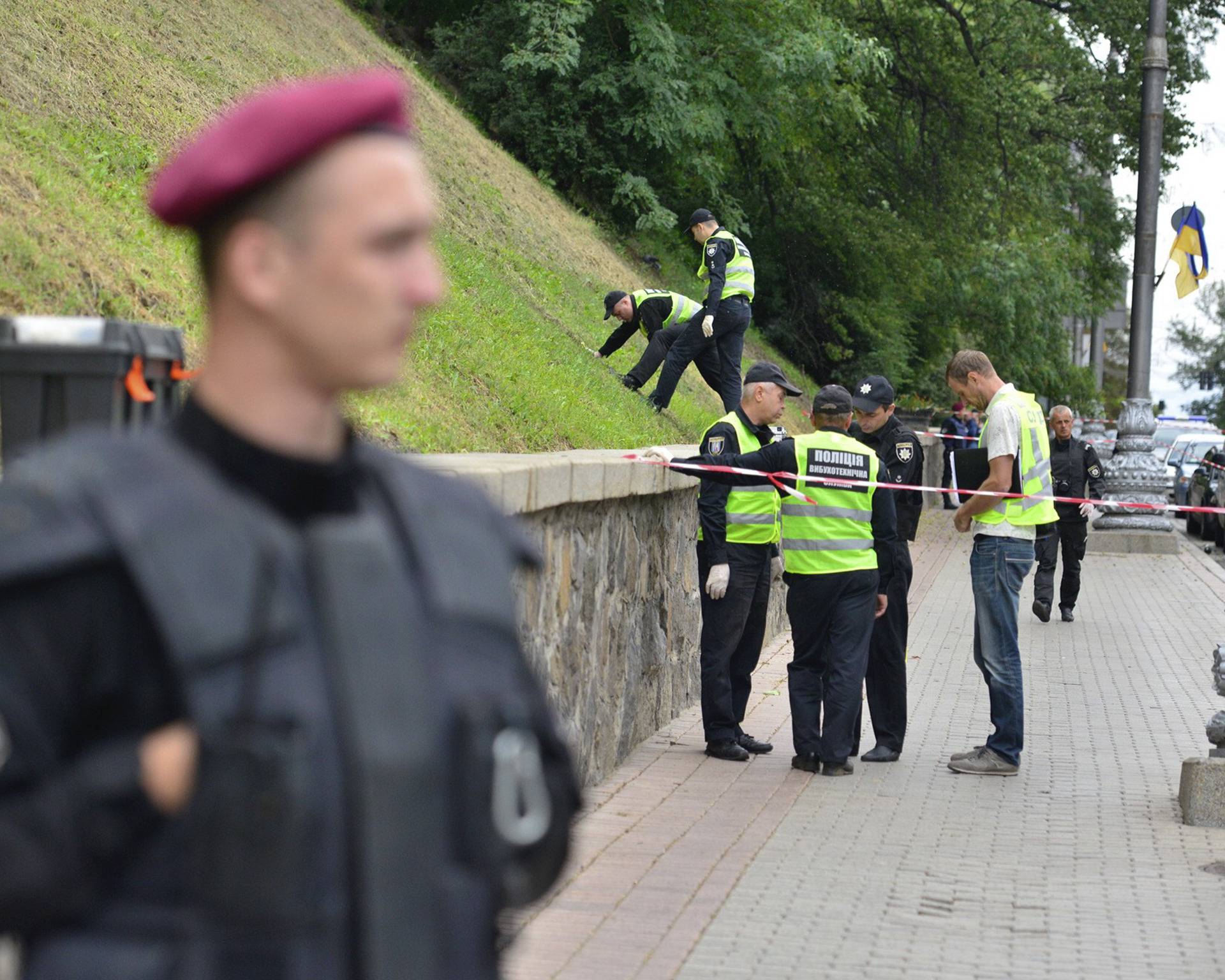 Investigators and policemen work at the site of an explosion in Kiev