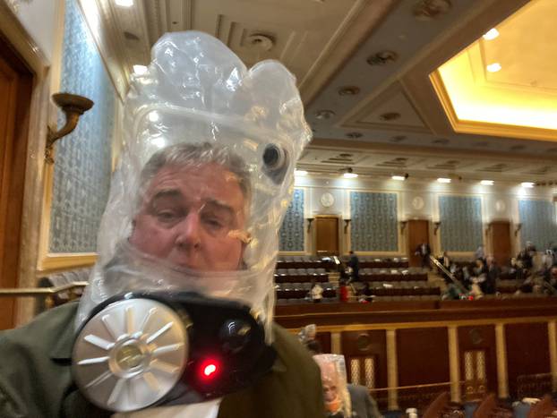 Rep. David Trone wears a gas mask inside the U.S. Capitol in Washington