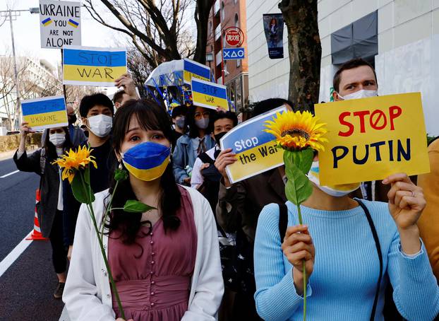 Protesters wearing protective masks, amid the coronavirus disease (COVID-19) outbreak, participate in a march to protest against Russia's invasion of Ukraine, in Tokyo