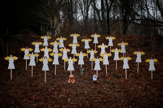 FILE PHOTO: Twenty-seven wooden angel figures are seen placed in wooded area beside road near Sandy Hook Elementary School for victims of school shooting in Newtown