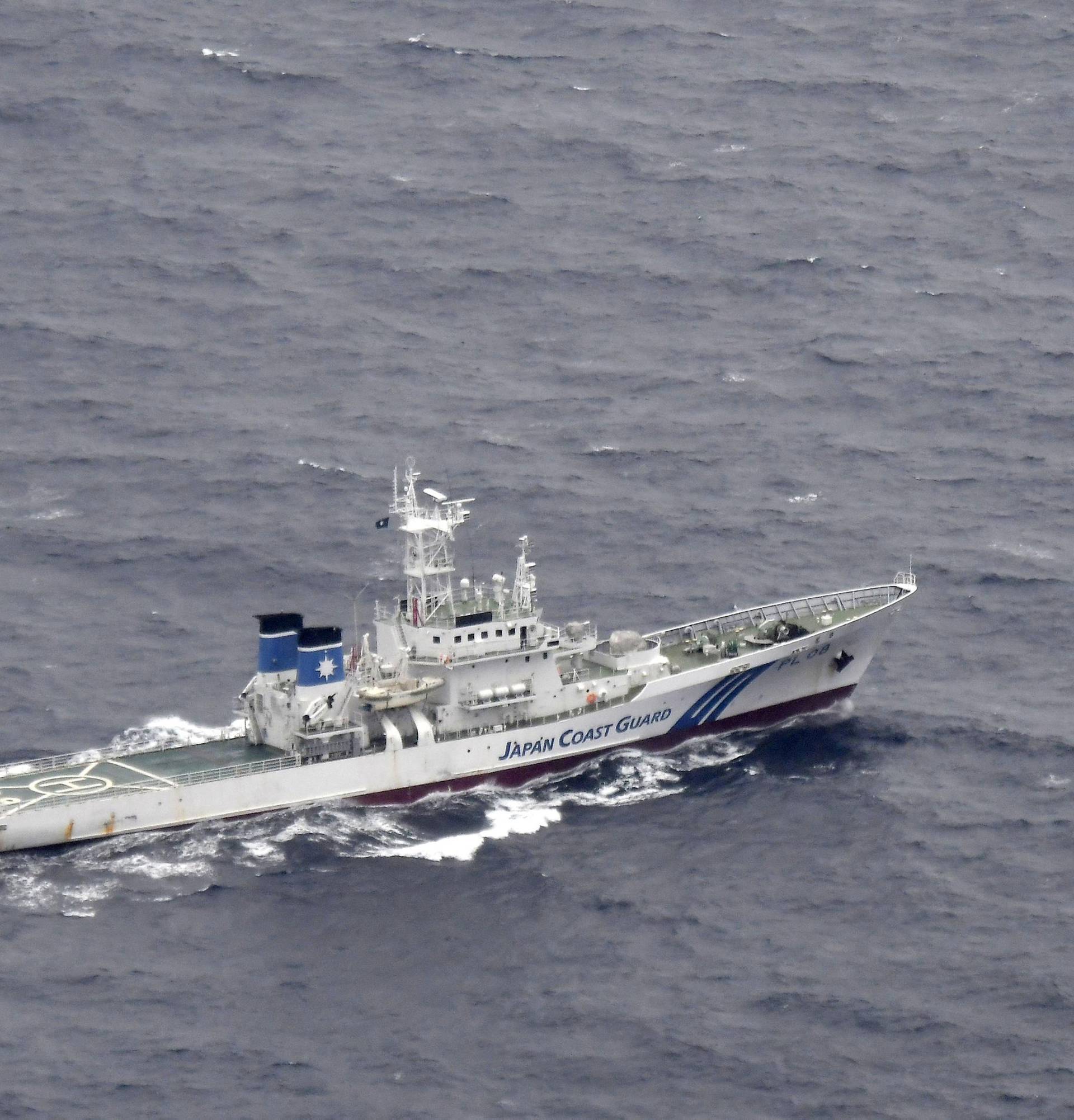 A Japan Coast Guard patrol vessel sails on the water at the area where two U.S. Marine Corps aircraft have been involved in a mishap in the skies, off the coast of Kochi prefecture, Japan