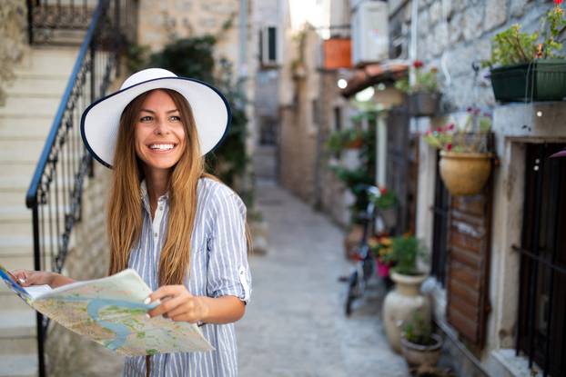 Happy young woman smiling and traveling at summer vacation