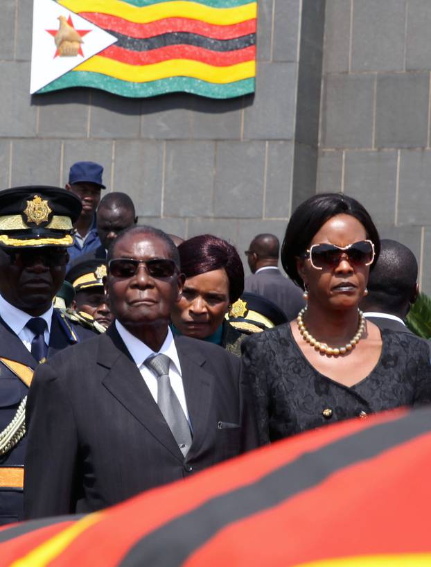 Mugabe and his wife Grace arrive for the burial of two independence luminaries in Harare