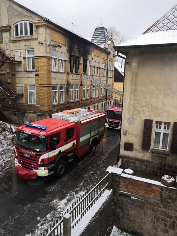 A firetruck is seen parked next to a building affected by fire, in Vejprty