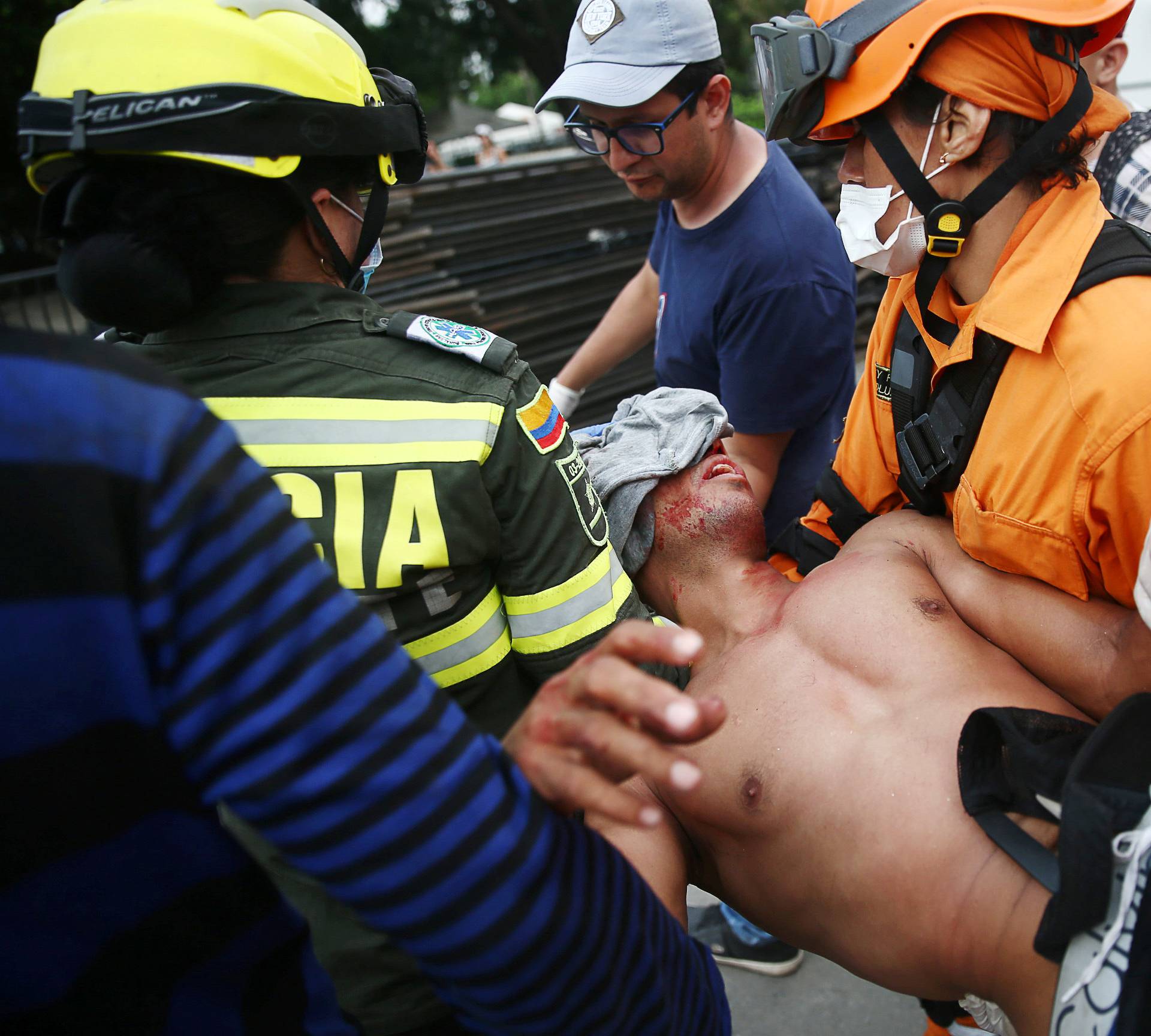 A demonstrator injured by a bullet is helped after clashing with Venezuela's security forces at Simon Bolivar bridge on the border line between Colombia and Venezuela