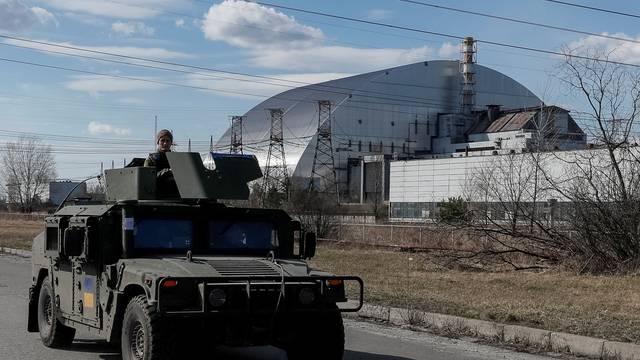 Servicemen of Ukrainian National Guard patrol area near the Chernobyl Nuclear Power Plant, in Chernobyl