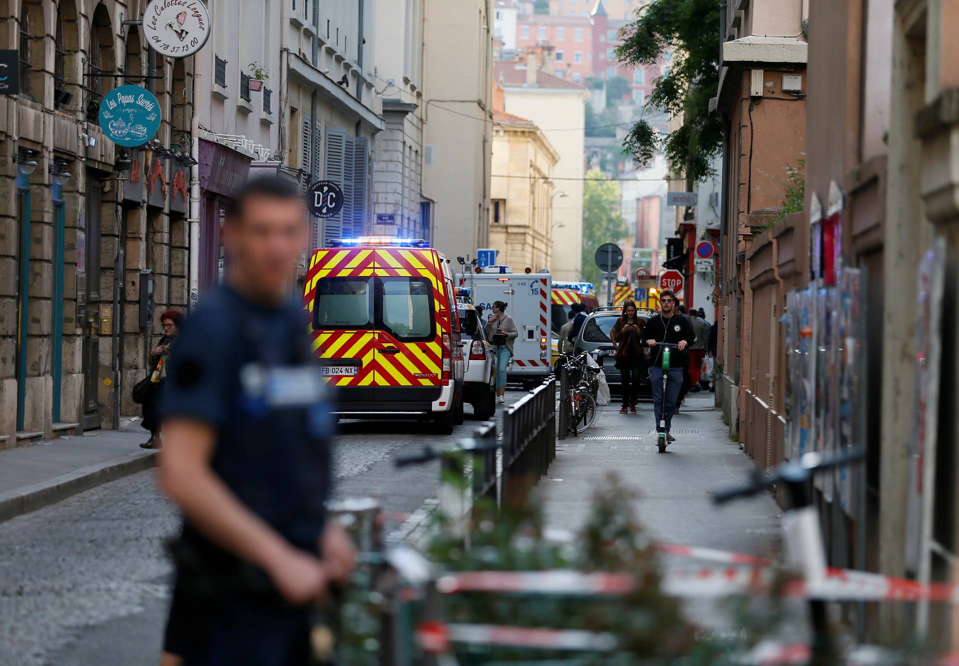 Fire brigade vehicles and ambulances are seen near the site of a suspected bomb attack in central Lyon