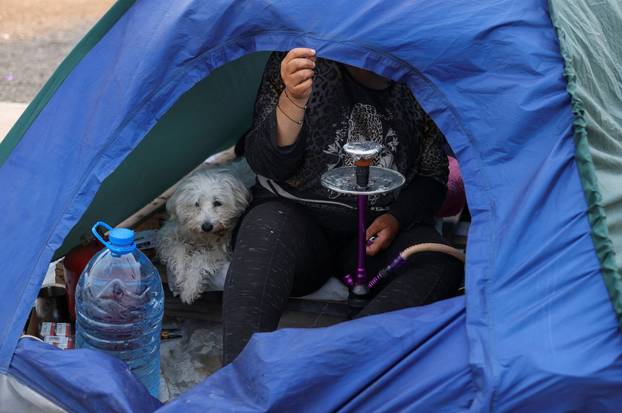 Displaced people shelter in a makeshift encampment in Beirut