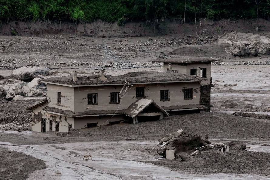 Mud covers a property following a flash flood at Trishuli, Nepal
