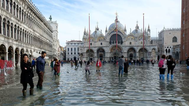 FILE PHOTO: Tourists walk in St. Mark’s Square after days of severe flooding in Venice