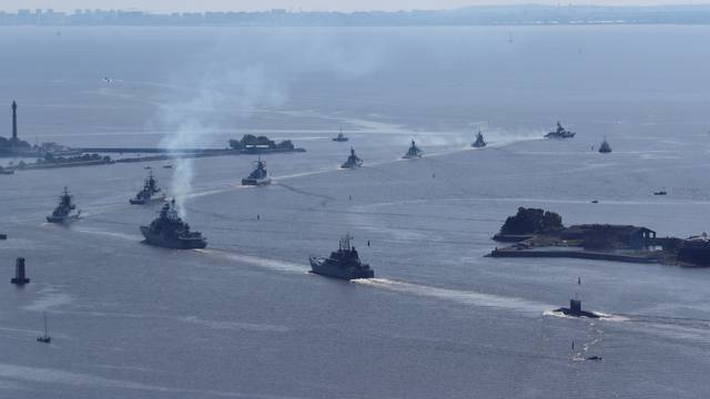 Russian warships and a military submarine sail during a rehearsal for the Navy Day parade near Saint Petersburg