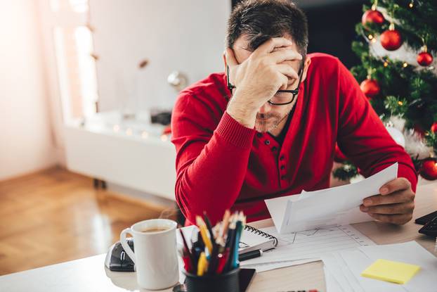 Man,Wearing,Red,Sweater,Reading,Letter,And,Holding,Hand,At