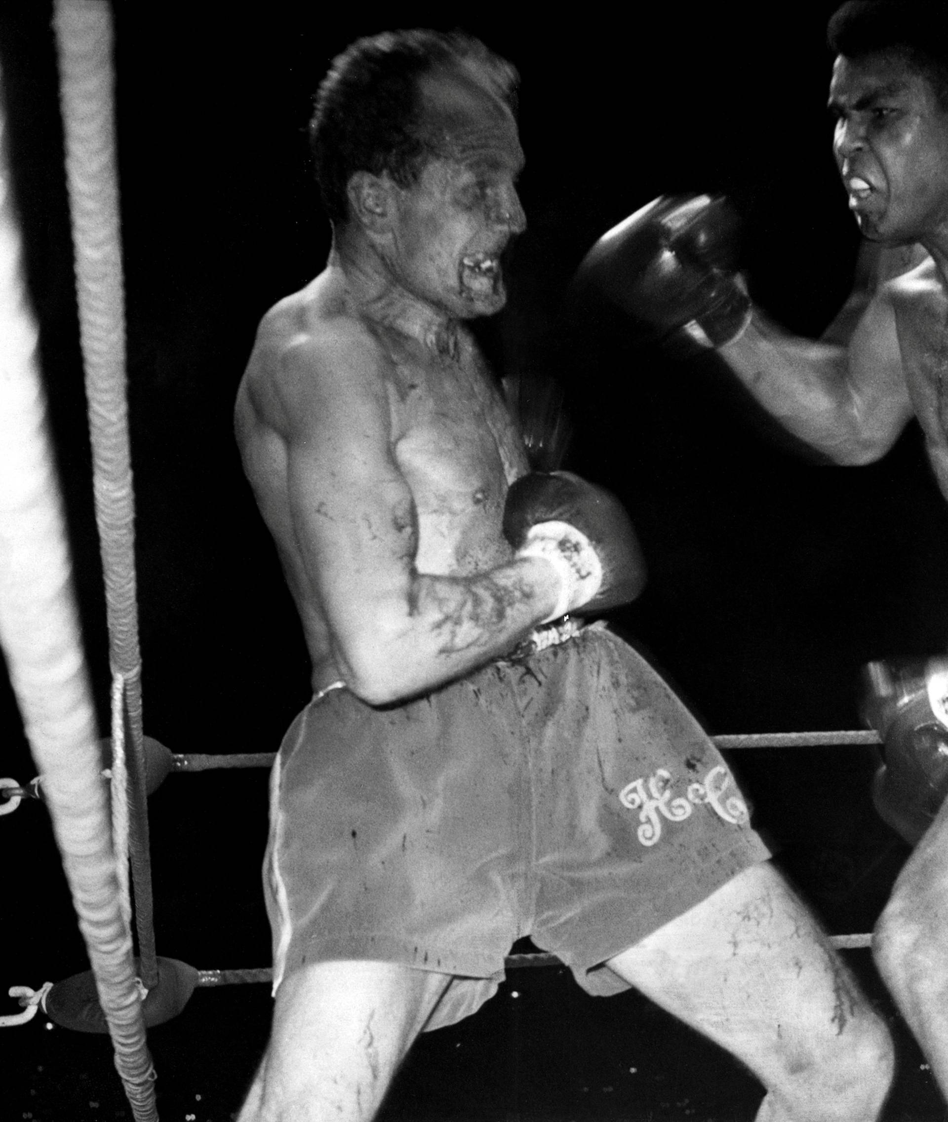  World Heavyweight Champion Muhammad Ali, (formerly Cassius Clay), and challenger Henry Cooper fight at Highbury Stadium, London