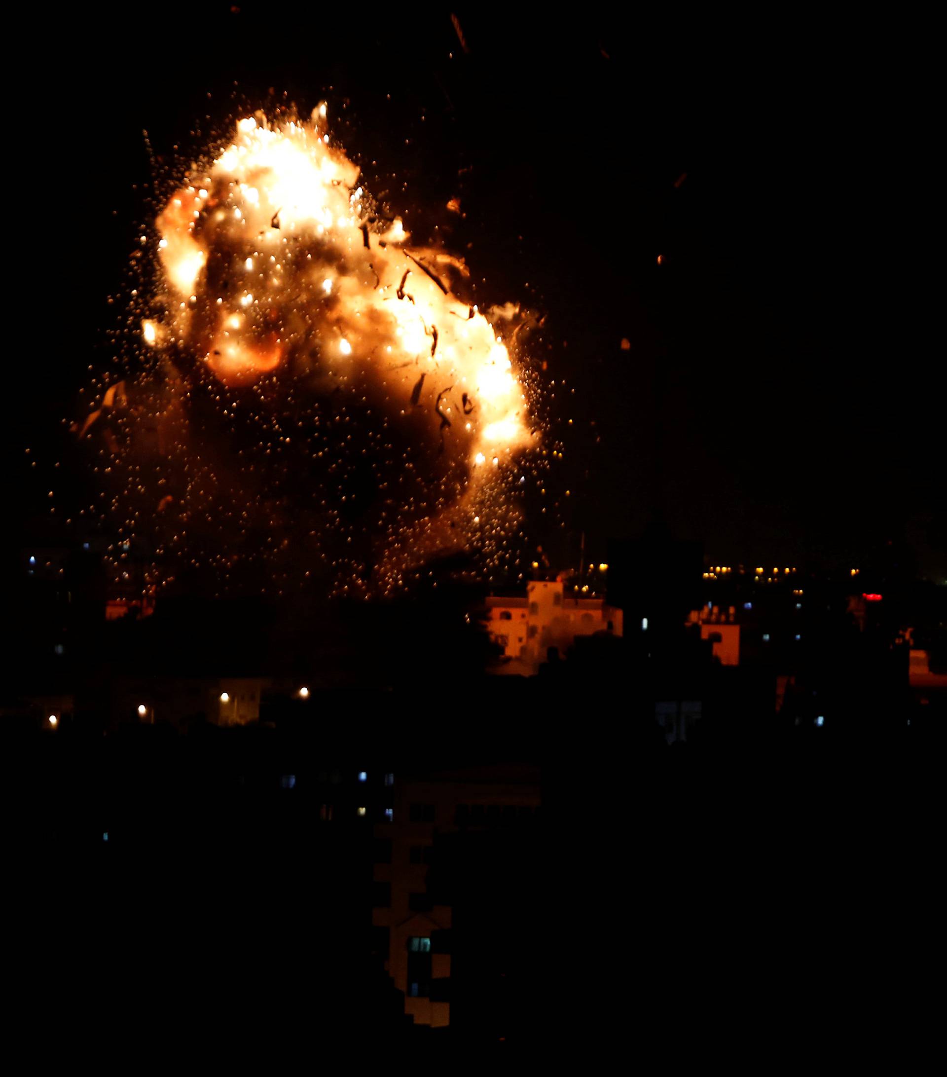 Explosion is seen during an Israeli air strike on Hamas's television station, in Gaza City