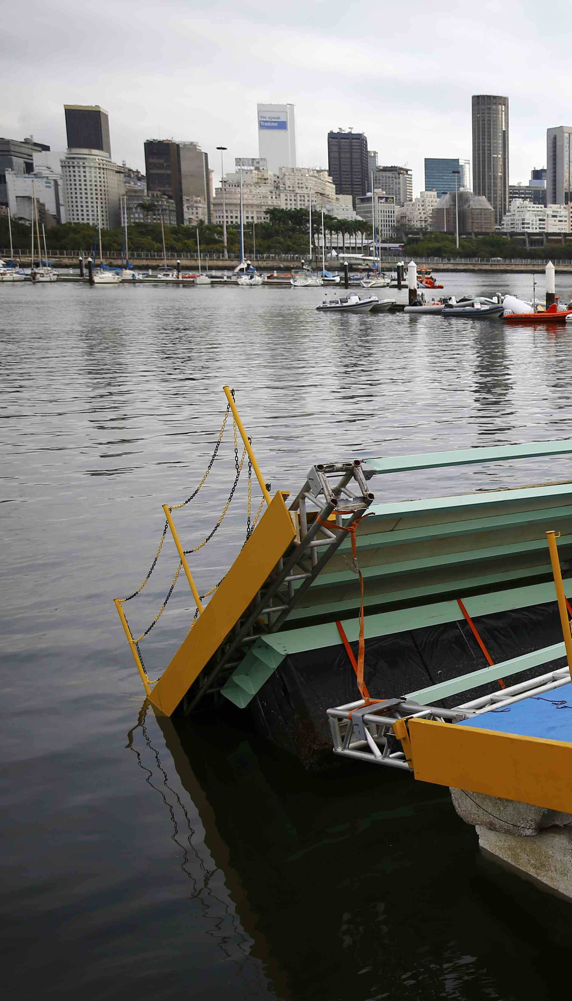 A ramp built for competitors' boats to reach the water hangs after collapsing at the Marina da Gloria in Rio de Janeiro