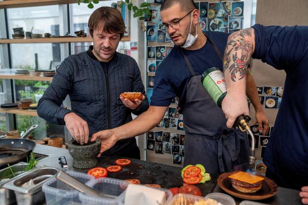 FILE PHOTO: Noma's Redzepi prepares a Noma vegetarian burger in Copenhagen