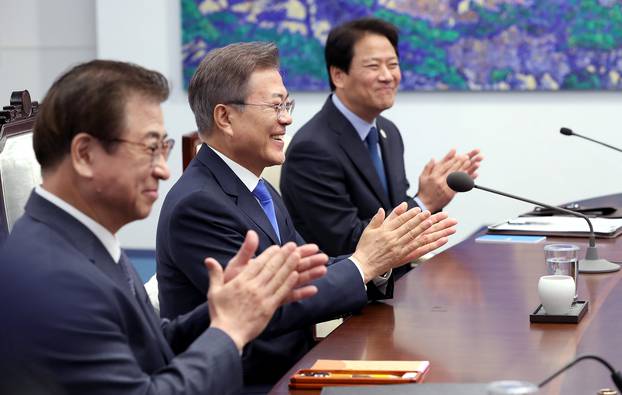 South Korean President Moon Jae-in applauds during a meeting with North Korean leader Kim Jong Un at the Peace House