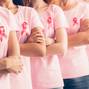 Unrecognizable Ladies In Cancer Awareness T-Shirts Posing Over White Background