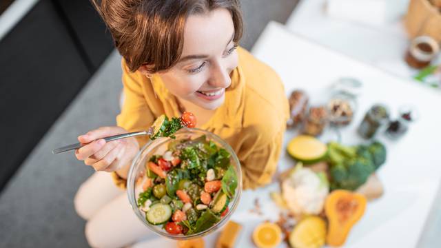 Portrait,Of,A,Young,Cheerful,Woman,Eating,Salad,At,The