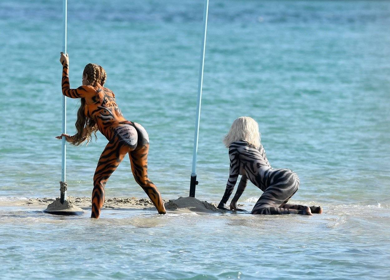 EXCLUSIVE: Rapper Cardi B. wears tiger body paint as she twerks on a sandbar during a video shoot in Miami