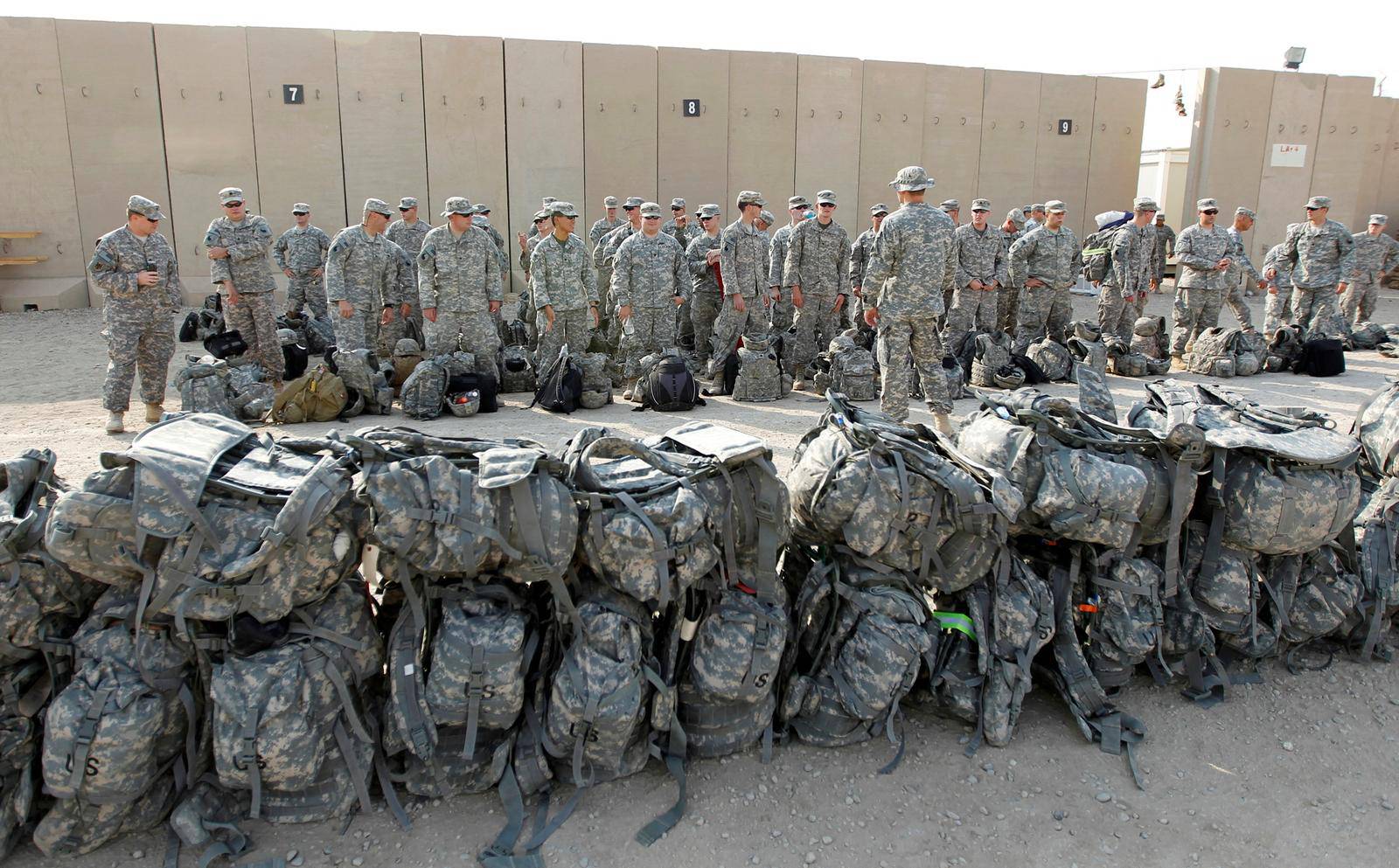 FILE PHOTO: U.S. soldiers of the 1st Battalion, 116th Infantry Regiment, wait to load their luggage as they prepare to pull out from Iraq and leave for Kuwait from Tallil Air Base near Nassiriya