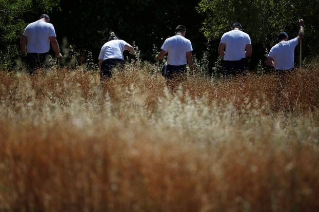 FILE PHOTO: Members of Scotland Yard work at an area during the search for missing British girl Madeleine McCann in Praia da Luz