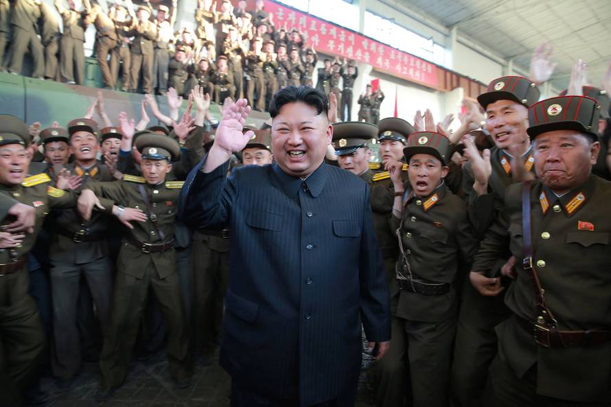 North Korean leader Kim Jong Un reacts with members of the Korean People's Army