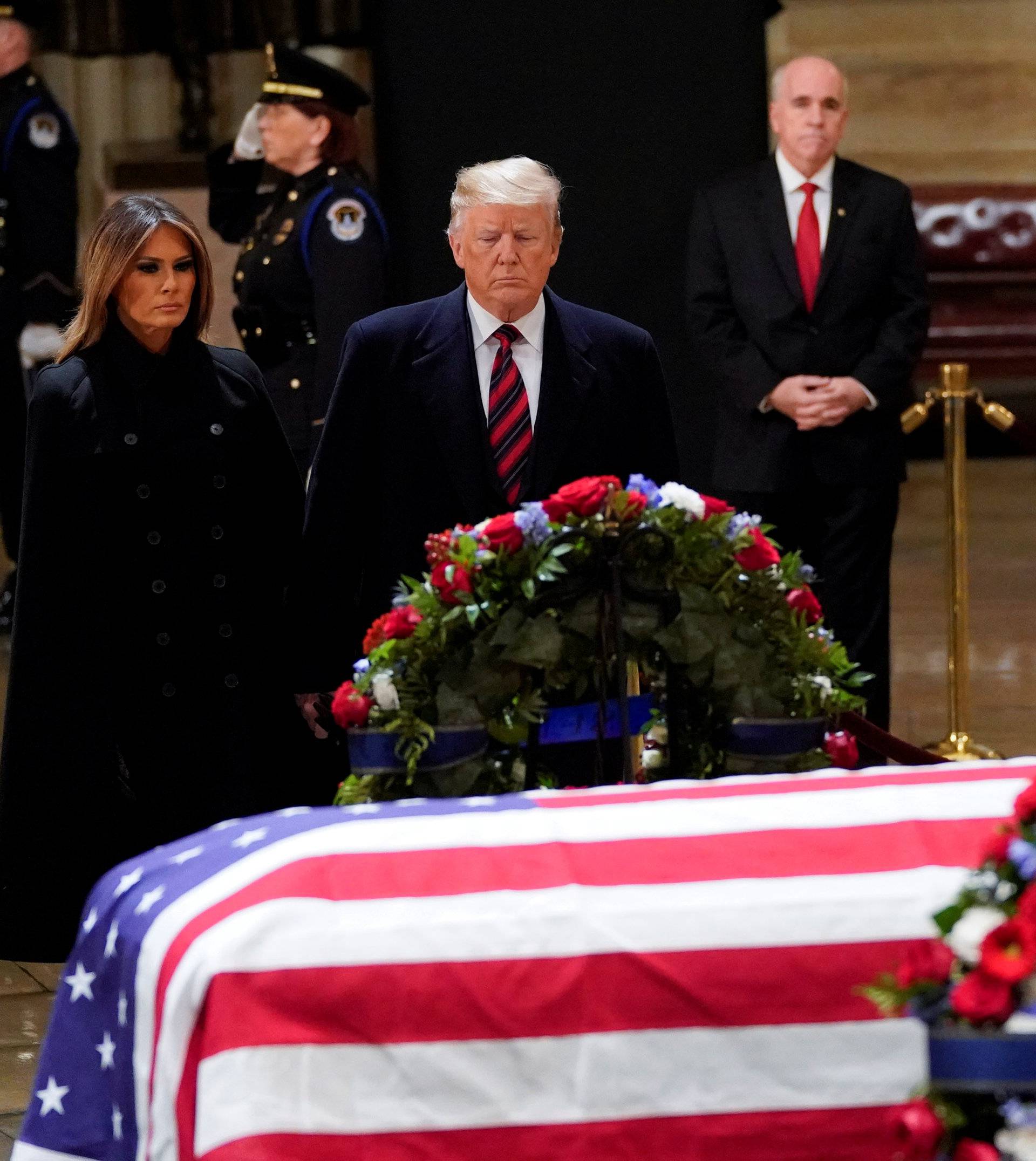 President Donald Trump and first lady Melania Trump pay their respects to former President George H. W. Bush lying in state in the U.S. Capitol Rotunda