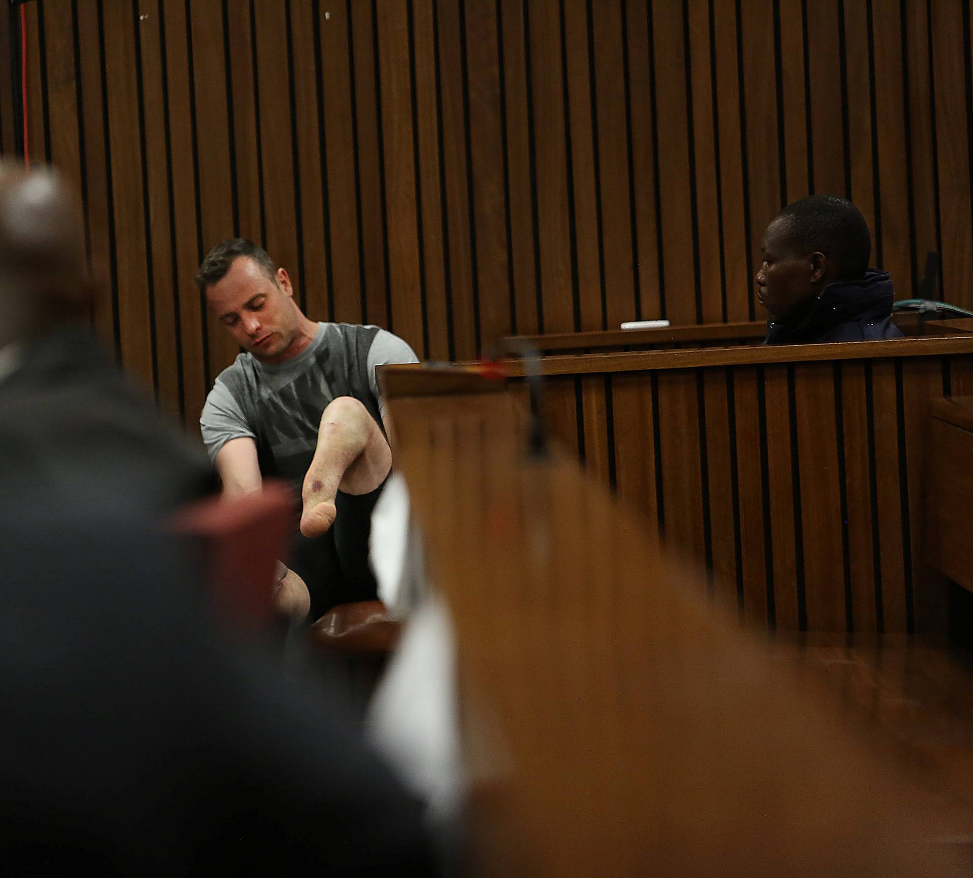 Paralympic gold medalist Oscar Pistorius sits in the dock during the third day of his resentencing hearing for the 2013 murder of his girlfriend Reeva Steenkamp